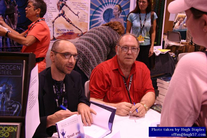 Nick DiChario and Mike Resnick sign autographs at Edge Press table